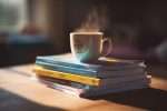 a-stack-of-study-guides-and-practice-tests-neatly-piled-next-to-a-cup-of-steaming-tea